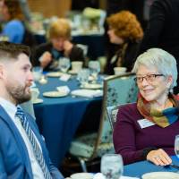 Two guests speaking at Scholarship Dinner 2019